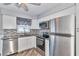Modern kitchen with stainless appliances, granite countertops, tile backsplash, and ample white cabinetry at 3045 Stratford Dr, Largo, FL 33771