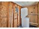 Compact laundry room with stacked washer and dryer, and modern water heater at 3045 Stratford Dr, Largo, FL 33771