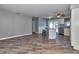 Open-concept living room with wood-look floors, kitchen island, and plenty of natural light at 3045 Stratford Dr, Largo, FL 33771