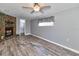 Cozy living room featuring wood-look floors, neutral paint, and a stone fireplace at 3045 Stratford Dr, Largo, FL 33771