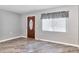 Cozy living room with wood-look floors, neutral paint, and a large window at 3045 Stratford Dr, Largo, FL 33771