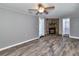 Spacious living room features wood-look floors and a stone fireplace with a wood mantle at 3045 Stratford Dr, Largo, FL 33771