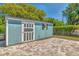 Backyard storage shed painted blue with white trim and decorative door at 3045 Stratford Dr, Largo, FL 33771