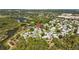 Aerial view of community featuring lush landscaping, a pool and a nearby body of water at 3204 40Th S Way # B, St Petersburg, FL 33711
