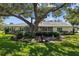 Spacious backyard featuring a large shade tree, patio area, and peaceful outdoor setting at 3204 40Th S Way # B, St Petersburg, FL 33711