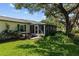 Relaxing backyard with a screened lanai, mature trees, and lush greenery for outdoor enjoyment at 3204 40Th S Way # B, St Petersburg, FL 33711