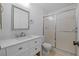 Bathroom featuring sleek vanity, updated fixtures, and a glass-enclosed shower at 3204 40Th S Way # B, St Petersburg, FL 33711