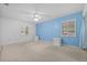Comfortable bedroom featuring neutral carpet, light fixtures, and shuttered windows at 3204 40Th S Way # B, St Petersburg, FL 33711