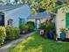 Charming single-story villa with lush landscaping and a cozy front entrance with beautiful plants at 3204 40Th S Way # B, St Petersburg, FL 33711