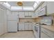 Well-maintained kitchen with white appliances, tile flooring, and functional layout at 3204 40Th S Way # B, St Petersburg, FL 33711