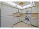Efficient kitchen featuring white appliances, ample cabinetry, and bright lighting at 3204 40Th S Way # B, St Petersburg, FL 33711