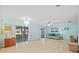 Bright living room with tile flooring, sliding glass doors, and ample natural light at 3204 40Th S Way # B, St Petersburg, FL 33711