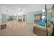 Spacious living room featuring tile flooring, a ceiling fan, and access to the screened lanai at 3204 40Th S Way # B, St Petersburg, FL 33711