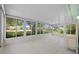 Inviting patio with bright white tile, screened windows, and natural sunlight at 3204 40Th S Way # B, St Petersburg, FL 33711