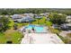 Inviting community pool area with lounge chairs, lush landscaping, and nearby residential buildings perfect for outdoor relaxation at 3204 40Th S Way # B, St Petersburg, FL 33711