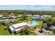 Aerial view of community pool, surrounded by lush greenery and residential buildings, perfect for relaxing and socializing at 3204 40Th S Way # B, St Petersburg, FL 33711