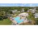 Aerial view of a community pool and clubhouse, creating a serene and inviting atmosphere for residents to enjoy outdoor recreation at 3204 40Th S Way # B, St Petersburg, FL 33711