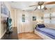 Bright bedroom with hardwood floors, a ceiling fan, and natural light from the window at 3214 W Rogers Ave, Tampa, FL 33611