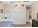 Cozy bedroom featuring wood floors, ample closet space and a ceiling fan at 3214 W Rogers Ave, Tampa, FL 33611