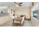 Dining room area with a wood table and white chairs, next to the kitchen at 3214 W Rogers Ave, Tampa, FL 33611