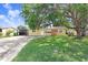 This property features a well-manicured lawn and mature trees at 3214 W Rogers Ave, Tampa, FL 33611