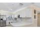 Clean kitchen featuring white cabinets, ample counter space, and modern appliances at 3214 W Rogers Ave, Tampa, FL 33611