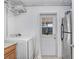 Laundry room features a washer and dryer with access to the backyard at 3214 W Rogers Ave, Tampa, FL 33611