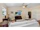 Comfortable living room with white sofa, a ceiling fan, and a television at 3214 W Rogers Ave, Tampa, FL 33611