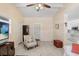 Open living room with neutral walls, ceiling fan, and tiled floor at 3214 W Rogers Ave, Tampa, FL 33611