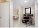 Entry hall with a desk and two monitors, leading to dining area at 3214 W Rogers Ave, Tampa, FL 33611