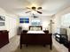 Bedroom featuring a comfortable bed, ceiling fan, and closet, with ample space for storage at 3240 Sand Key Dr, Palm Harbor, FL 34684