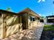Back exterior featuring an outdoor storage area, well-maintained backyard, and brick pavers at 3240 Sand Key Dr, Palm Harbor, FL 34684