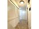 Hallway with tiled floors, recessed lighting, and closet with sliding doors at 3240 Sand Key Dr, Palm Harbor, FL 34684