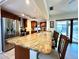 Spacious kitchen features a large granite countertop island, stainless steel appliances, and wood cabinetry at 3240 Sand Key Dr, Palm Harbor, FL 34684