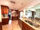 Spacious kitchen boasting custom cabinets, granite countertops, stainless steel appliances, and stylish tile flooring at 3240 Sand Key Dr, Palm Harbor, FL 34684