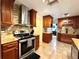 Well-equipped kitchen features tile backsplash, granite counters, stainless steel appliances and wood cabinets at 3240 Sand Key Dr, Palm Harbor, FL 34684