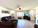 Comfortable living room with hardwood floors, a ceiling fan, and a large leather sectional at 3240 Sand Key Dr, Palm Harbor, FL 34684