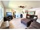 Spacious living room with a ceiling fan, comfortable seating, and a view of the dining area at 3240 Sand Key Dr, Palm Harbor, FL 34684