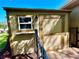 Exterior storage shed with window, secure door, and brick-paved path at 3240 Sand Key Dr, Palm Harbor, FL 34684