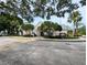 Charming community clubhouse with manicured landscaping, trees, and plenty of parking at 3305 Haviland Ct # 301, Palm Harbor, FL 34684