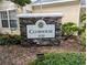 Stone clubhouse sign with address number 3320 in a well maintained community at 3305 Haviland Ct # 301, Palm Harbor, FL 34684