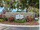 Elegant entrance to the community with manicured landscaping and attractive signage at 3305 Haviland Ct # 301, Palm Harbor, FL 34684