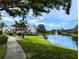 Lush landscaping surrounding the community pond with water fountain feature at 3305 Haviland Ct # 301, Palm Harbor, FL 34684