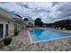 Relaxing pool area with lounge chairs and a charming brick deck at 3305 Haviland Ct # 301, Palm Harbor, FL 34684