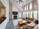 A well-lit living room featuring a vaulted ceiling, fireplace, and modern flooring at 3305 Haviland Ct # 301, Palm Harbor, FL 34684