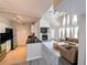 A well-lit, open floor plan featuring a vaulted ceiling, fireplace, and kitchen access at 3305 Haviland Ct # 301, Palm Harbor, FL 34684