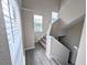 Bright stairwell with neutral walls and carpeting, offering a transition between levels at 3305 Haviland Ct # 301, Palm Harbor, FL 34684