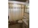 Bathroom featuring a shower with curtain, toilet, and sink at 4237 Tamargo Dr # 4237, New Port Richey, FL 34652