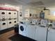 Clean community laundry room with coin-operated washers and dryers at 4237 Tamargo Dr # 4237, New Port Richey, FL 34652