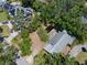 Overhead shot of the property showing lush greenery, a pond, and the roof's layout at 4315 W Azeele St, Tampa, FL 33609